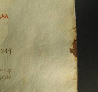 Fore edge mark: thread and leather remaining in Quire 64, 1r (British Library f.128)